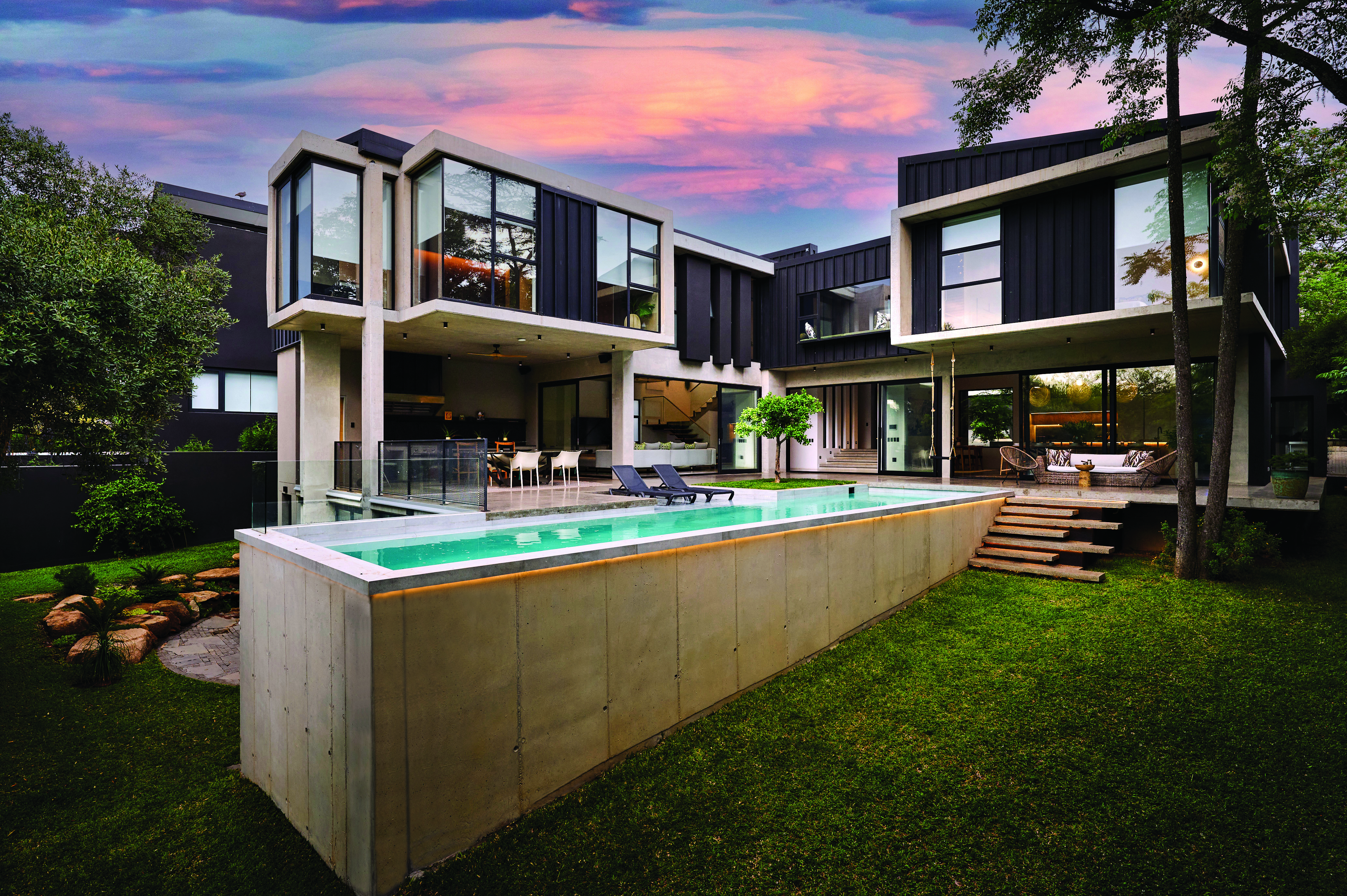 Contemporary flat-roof villa photographed at dusk