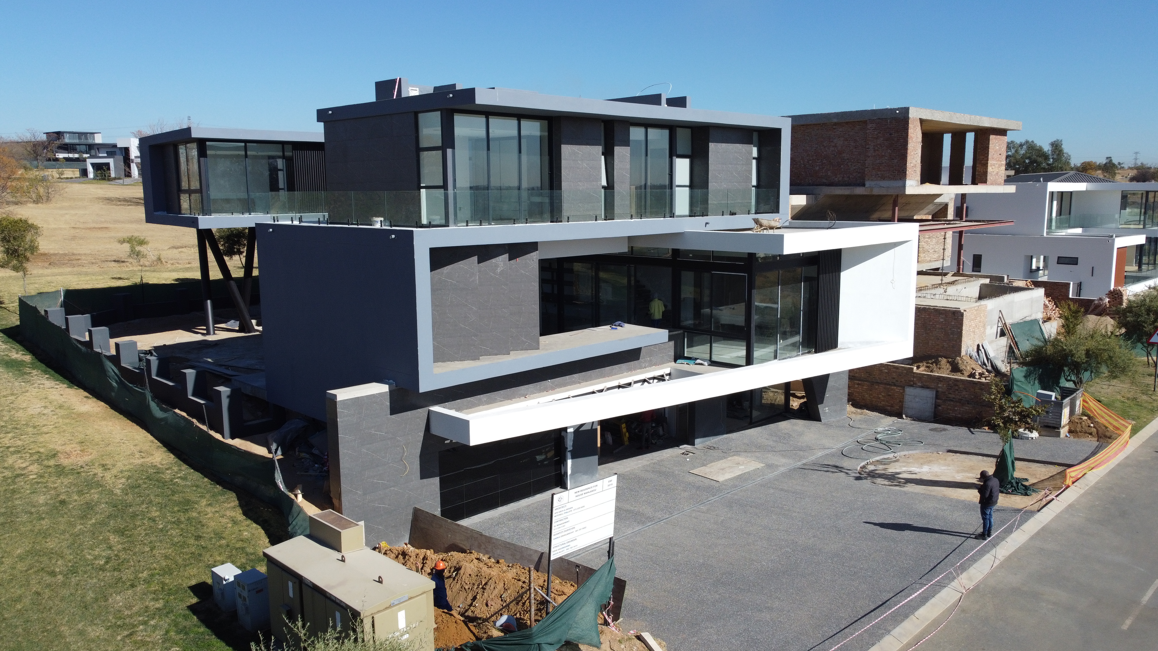 Aerial of a dark-cladded contemporary home under construction